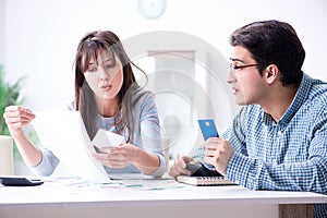 The young couple looking at family finance papers