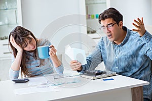 The young couple looking at family finance papers