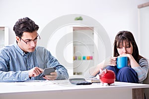 The young couple looking at family finance papers