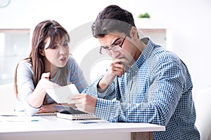 The young couple looking at family finance papers