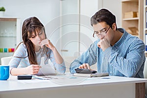 The young couple looking at family finance papers