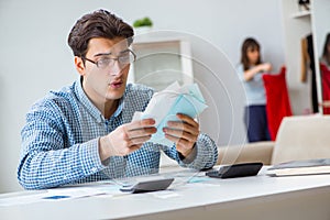 The young couple looking at family finance papers