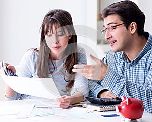 Young couple looking at family finance papers