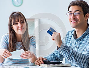 Young couple looking at family finance papers