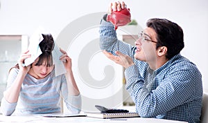 Young couple looking at family finance papers