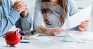 Young couple looking at family finance papers