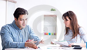 Young couple looking at family finance papers