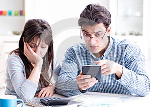 Young couple looking at family finance papers