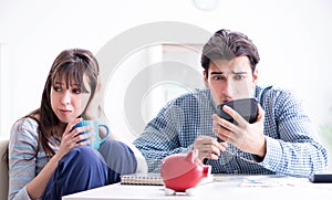 Young couple looking at family finance papers