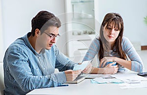 Young couple looking at family finance papers