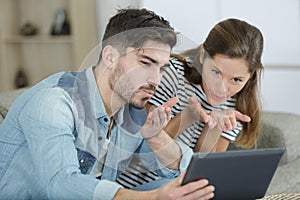 young couple looking at laptop screen for videocall