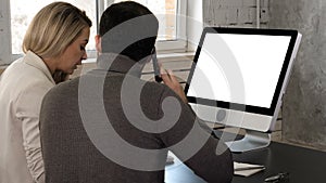 Young couple looking at monitor talking. Man makes a call. White Display.