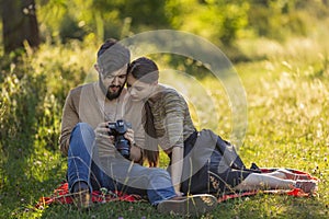 young couple looking at photos on a camera