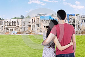 Young couple looking at residential construction