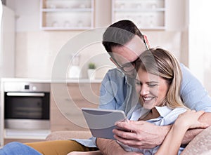 Young couple looking at tablet at home