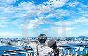 Young couple looking at the view of enoshima photo
