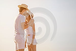 Young couple in love at beach . boyfriend kissing  girlfriend  on the forehead . happy .Romantic  in sunset outdoor. asian .