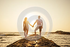 Young couple in love on the beach February 14, St. Valentine`s Day sunset Goa India vacation trip .travel new year in a