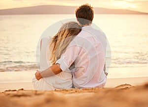 Young couple in love on the beach sunset