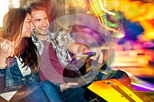 Young couple in love in a bumper car / dodgem ride photo