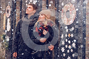 Young couple in love couple travels on St. Valentine`s Day. Holidays in Europe. Warm clothes, hat. scarf, nice atmosphere. Winter,