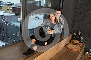Young couple in love with denim jacket sitting