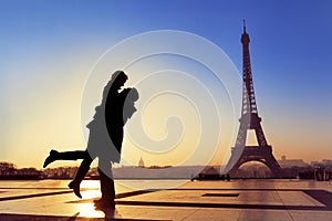 Young couple in love at Eiffel Tower, Paris, France