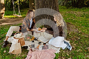 Young couple in love enjoying food during picnic time in park