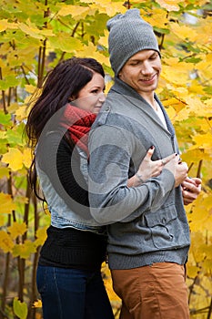 Young couple in love frolicking in a park photo