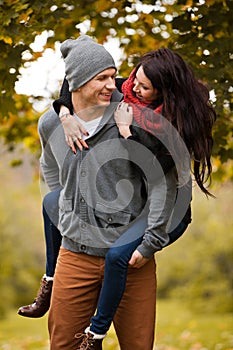 Young couple in love frolicking in a park photo