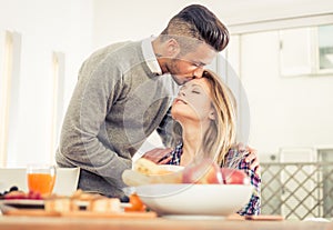 Young couple in love having breakfast at home.