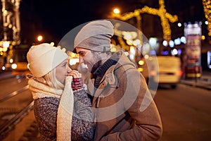 A young couple in love having moments of closeness in a walk of the city. Relationship, together, Xmas