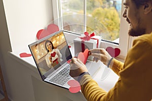 Young couple in love having romantic date via video call on Saint Valentine`s Day