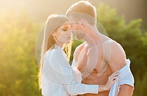 Young couple in love hug each other at sunset. Love story.