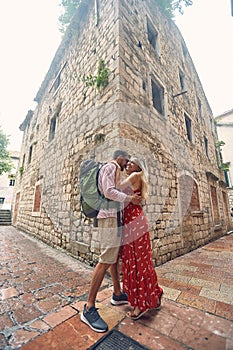 A young couple in love is in a hug while walking the old city during a vacation on the seaside. Vacation, seaside, relationship,