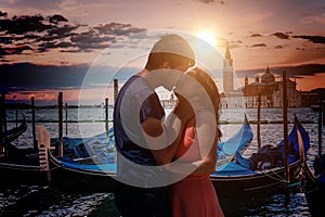 Young couple in love is kissing in Venice in Italy