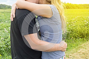 Young couple in love men and women hugging on grass background, Sunny summer day in the countryside in nature