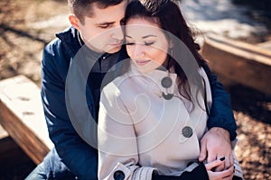 Young couple in love outdoor. They are smiling and looking at each other