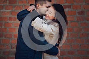 Young couple in love outdoor. They are smiling and looking at each other