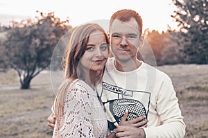 Young couple in love outdoor. They are smiling and looking at each other. evening sunlight, hugs and kisses, vintage style