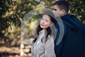 Young couple in love outdoor. They are smiling and looking at each other