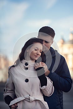 Young couple in love outdoor. They are smiling and looking at each other