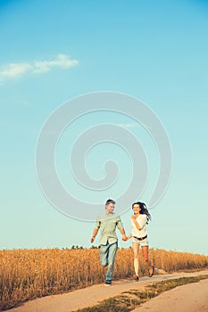 Young couple in love outdoor.Stunning sensual outdoor portrait of young stylish fashion couple posing in summer in field