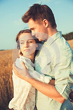 Young couple in love outdoor.Stunning sensual outdoor portrait of young stylish fashion couple posing in summer in field.Happy