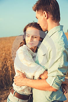 Young couple in love outdoor.Stunning sensual outdoor portrait of young stylish fashion couple posing in summer in field