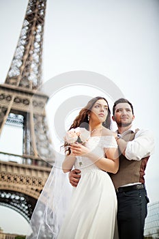 Young couple in love in paris on their wedding day