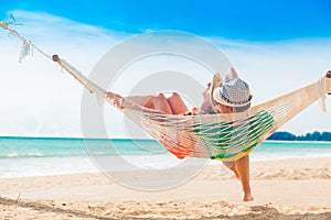 Young couple in love relaxing in a hammock by the beach