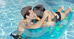 Young couple in love relaxing in the pool