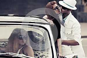 Young couple in love at the retro car