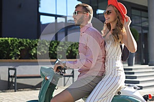 Young couple in love riding a motorbike. Riders enjoying themselves on trip. Adventure and vacations concept